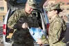 Maj. Georgel Oanca, brigade chaplain, 4th Combat Aviation Brigade, 4th Infantry Division, gives a turkey to a 4th Infantry Division Soldier to help contribute for Thanksgiving meals Nov. 19. 