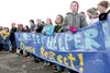 Palmer Junior Middle School students stand with their banner as Gov. Sean Parnell speaks to the crowd gathered in downtown Palmer for a ‘Choose Respect’ march Thursday afternoon. ROBERT DeBER