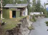 ANDREW WELLNER/Frontiersman Swelling Matanuska River has eroded
its banks to the point where nearby homes are threatened. Here, the
back addition to this home north of Palmer fell into the ri
