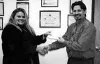 Alaska Family Resource Center Executive Director Amy Smith
accepts a check for $1,900 from Valley A.B.A.T.E President Mac
Aanerud. The money was raised during a charity auction. Submitted
pho