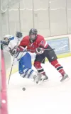 ROBERT DeBERRY/Frontiersman Palmer junior Dylan Danielowski
takes a hit from behind and is crushed into the boards late in the
second period of Palmer’s 8-3 win over Kenai. Danielowki was
inj