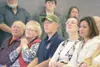 ROBERT DeBERRY/Frontiersman Army Spc. Joshua Revak, center, sits
and listens during a ceremony honoring Army Spc. Shane Woods Friday
at the Palmer Train Depot. Revak served with Woods and was