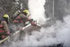 Firefighters with Central Mat-Su use a chainsaw to cut a hole in the roof during a house fire Monday off W. Sarah’s Way in Wasilla. Photos by HEATHER A. RESZ/Frontiersman