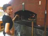 Rachel Campbell, a baker at the Flying Squirrel Bakery in Talkeetna, works on making pizzas in a hand-built wood-fired oven on Jan. 14. MARY LOCKMAN/Frontiersman