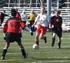 Wasilla's Beck Hesselbach, center, maneuvers for an open kick as
Houston defenders close in to stop her. Photo by TIM
BRODT/Frontiersman.
