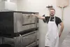 Pizza Ria Delphi Express owner John Christensen shows off the restaurant’s refurbished ovens. The new take-out and delivery business features much of the same menu as the Palmer restaurant, w