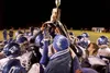 (ROBERT DeBERRY/Frontiersman) Palmer Mayor John Combs presents
the potato bowl trophy to the victorious Palmer Moose footbal team
Friday after the Moose defeated the Wasilla Warriors 48-7.