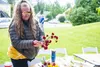 Evlyn Jackson arranges a bunch of flowers at a previous Palmer Museum Garden &amp; Art Faire. Frontiersman file photo.