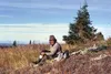 The author takes a break and adjusts his boots on the day when
he figures the moose hunting involved 18 miles of hiking to reach
areas to call and glass for bulls. Photo by Nick Dudiak