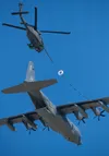 A ski-equipped UH-60 Blackhawk refuels from a C-130 Hercules during the Joint Forces demo at Arctic Thunder Saturday.
