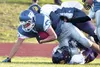 Palmer’s Cody Wells is brought down by Lathrop’s Derrick O’Neal, bottom, and Kaelen Lee, top, during second-quarter action Friday at Lathrop High School. ERIC ENGMAN