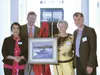 Visiting artist Dean Larson presents an original oil painting titled ‘Fresh Snowfall’ to the college in memory of former Mat-Su College Director Al Okeson. Pictured accepting the gift are Dir