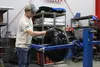 Chris King coats bushwheels at Airframes Alaska. Tim Rockey / Frontiersman