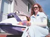 Jane Cain sits beside her broken jet ski Wednesday on the porch
of her Wasilla home soon after being released from Valley Hospital.
Hit by a float plane Monday on Big Lake, Cain doesn't plan 