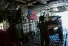 A U.S. Air Force loadmaster assigned to the 352d Special Operations Wing signals to service members from the U.S. Army’s 1st Battalion, 10th Special Forces Group and members from the Zapovjed