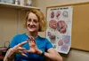 Patty Raymond-Turner, a coordinator for the Brain Injury Council of Alaska, demonstrates what happens to the brain when it is injured, on Sept. 26, 2023, in Anchorage.  Claire Stremple/Alaska