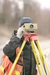 ROBERT DeBERRY/Frontiersman DOWL surveyor Mike Sinnett adjusts
his equipment while surveying along South Colony Way Friday
morning.