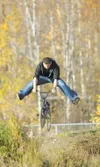 ROBERT DeBERRY/Frontiersman Dominik Dalton executes a no-footer
over a dirt jump at the BMX park in Wasilla Monday afternoon.