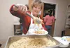 Lynette Ortolano, program director for The Children’s Lunchbox, serves up pasta at an open house celebration at the Boys and Girls Club in Wasilla Monday evening. The program began feeding Ma
