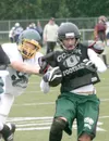 Colony senior Jaron Murphy is tackled after a gain during a
scrimmage against Service at Anchorage Football Stadium on
Saturday. Colony saw action against the Cougars, East and West
during th