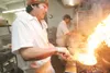 Indian cuisine chef Tsering Ludoe creates some heat as he
prepares an authentic Indian dish recently at the India Palace in
Wasilla. ROBERT DeBERRY/ Frontiersman