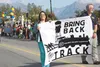 Jamie Duhamel and LaMarr Anderson supporter carry a banner for the ‘Palmer Colony Express’ entry in the Alaska State Fair Parade in downtown Palmer Aug. 23. The entry was picked as the ‘Overa
