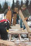 Workers hammer together one of two bridges built over the
weekend to protect salmon streams from all-terrain-vehicle
crossings. Photos courtesy of Catherine Inman.