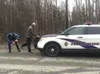 An Alaska State Trooper examines the shoes of Richard "Ole" Larson March 30, 2016, after Larson shot a man fleeing a police chase in Larson's Wasilla neighborhood. Palmer District Attorney Ro