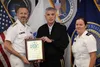 Royal Canadian Navy Commodore Matthew Bowen (left), J5 Multinational Partnership and Integration vice, accepts a plaque from U.S. Army Gen. Paul M. Nakasone, U.S. Cyber Command commander and 