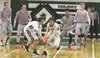 Colony's Nolan Martin and Sullivan Menard scramble to pick up the loose basketball during a 59-50 win over rival Wasilla Saturday at Colony High School. Courtesy of Bruce Eggleston/matsusport