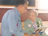 GREG JOHNSON/Frontiersman Mary Harvey reminisces with Erling
Nelson at a reception in her honor Monday at the Old Wasilla town
site near the Dorothy Page Museum.