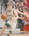 Colony forward Grant Niver charges past Kenai Kardinal Nate
Saltzgiver during Saturday's Northern Lights Conference
championship game at Palmer High School. (ROBERT
DeBERRY/Frontiersman)
