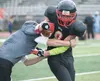 Returning Houston Hawk Waylon Soptick pushes past a Nikiski Bulldog during Saturday’s Chugiak Stampede at Chugiak High School. ROBERT DeBERRY/Frontiersman.com