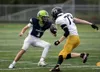 Redington quarterback Christian Ingraham tries to avoid the pressure during a loss to Homer. Bruce Eggleston/matusports.net