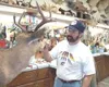Dan Foster touches up the eye lids of a Sitka black tail deer in
his taxidermy studio. Foster does custom mounts and restoration
work and clients have been calling to have him fix trophy moun