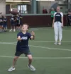 A participant catches a pass in a drill during the Seattle Sea Hawkers flag football clinic as Seattle Seahawks executive Becca Stout looks on Thursday, July 11, 2024, at the Menard Center in