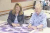 GREG JOHNSON/Frontiersman Sue Cuzzocreo, left, and Judy Foster
share a laugh while tying a purple patchwork quilt at Saturday’s
Sew for Service event at the Palmer Depot.