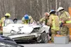 Central Mat-Su Fire Department rescue personnel tend to two
people involved in a three car accident at the corner of Bogard and
Engstrom roads Friday afternoon. (ROBERT DeBERRY/Frontiersman)