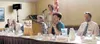 Doreen Toller, at the podium, served as emcee at the Mat-Su
Convention and Visitors' Bureau candidate forum last week, where
candidates discussed tourism-related issues. Photo by RINDI
WHITE/