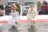 Joy Rudolph and Megan Stevens take the plunge dressed for a
wedding during the 2011 Valley Polar Plunge on Finger Lake Saturday
afternoon. ROBERT DeBERRY/Frontiersman