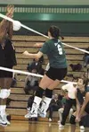 Colony's Chelayne Dukart delivers a shot across the net past
attempting East blockers in the third game of Thursday's match with
East High School. Photo by TIM BRODT/Frontiersman.