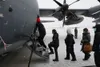 Students and staff from the Kusilvak Career Academy walk onto a HC-130J Combat King II during a tour given by the Alaska Air National Guard on Joint Base Elmendorf-Richardson, April 5, 2024. 