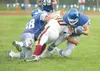 ROBERT DeBERRY/Frontiersman Palmer senior Mike Daniels gets
taken down by Dimond’s Randell Waters as Palmer’s Wes Jansen
attempts to block. The Moose meet the Wasilla Warriors in the
Potato B