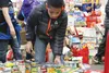 Fourth-grader Deshawn Campbell loads canned goods onto a cart at Machetanz Elementary School in Palmer Monday. The school collected 4,490 pounds of food for the Food 4 Kids program operated b