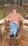 Rory Egelus relaxes in a willow branch chair he created last
summer. Egelus has been making furniture from willow branches since
last March, and some of his pieces have been raffled by commun