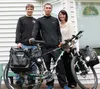 Dan Jenkins, Jacky Chen and Amy Jenkins on the porch of the Jenkins’ home in Palmer. Chen stayed with the Jenkins family and experienced Valley life during his bike trip around the world. He 