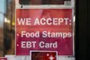 A sign for a store that accepts food stamps and exchange benefits transfer cards is seen in this 2019 photo. Ten Alaskans are suing the state over its failure to provide food stamps within th