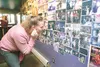 ROBERT DeBERRY/FrontiersmanFormer Dead Dog employee Shirley
Wines looks at the wall of photos inside the Meadow Lakes bar
during their final party Friday night. Wines said the the photos on
t
