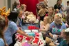 Volunteers at a Build-A-Bear station help children put together their stuffed animals during the 9th annual Winter Wonderland Extravaganza held for military families at the Ritz Carlton in Ar