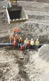 Work to install a 9,800-foot water main connecting the Mat-Su
College campus to the city of Palmer’s water supply was completed
recently. Pictured following the installation of the final hook